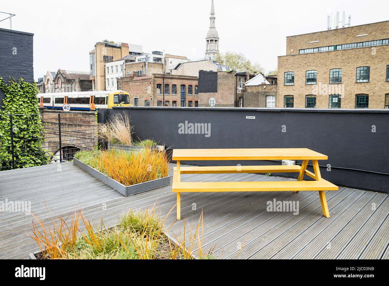Detail of rooftop patio in London with train passing by Stock Photo Alamy