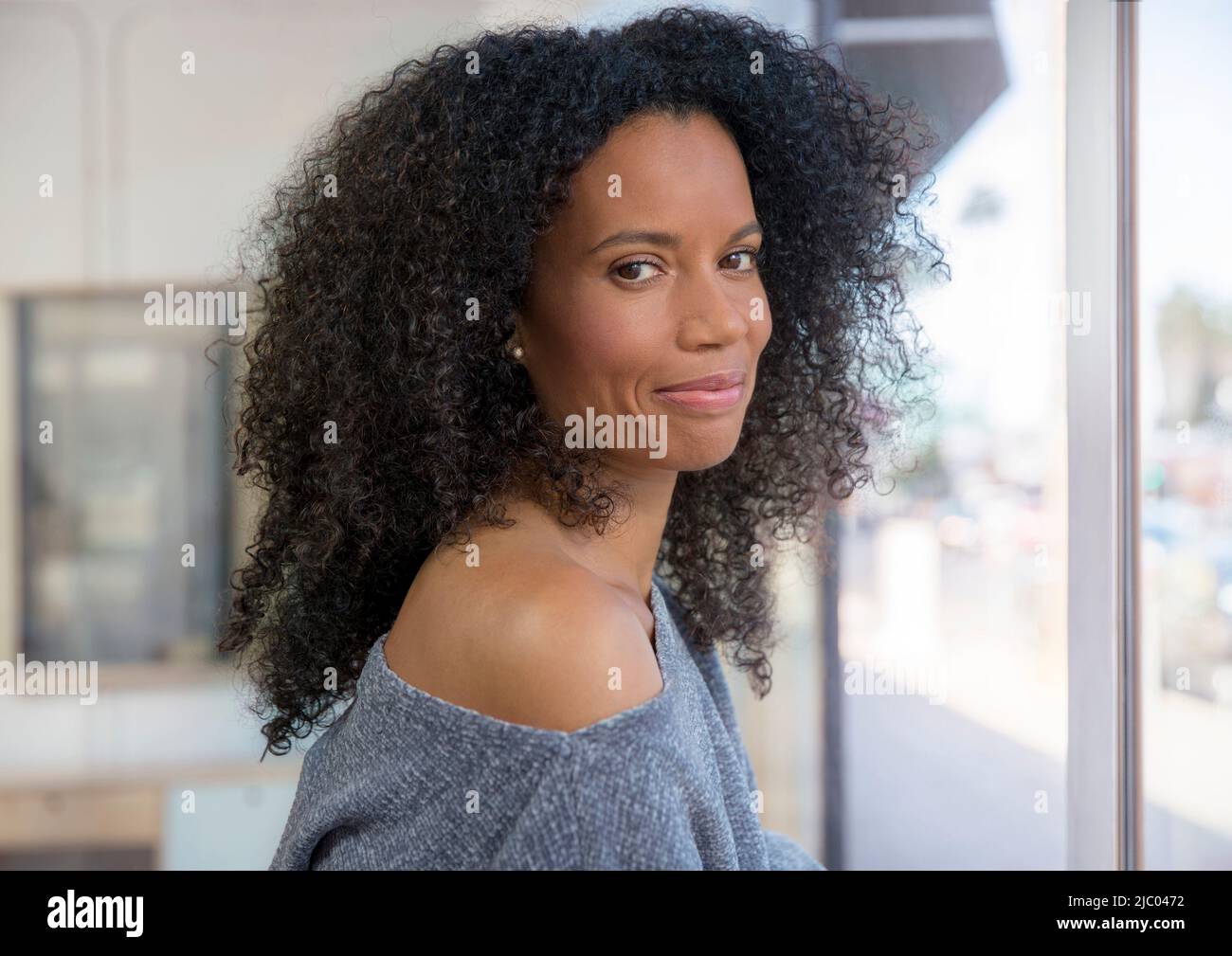 Portrait of a mixed race, middle-aged woman looking into camera confidently. Stock Photo