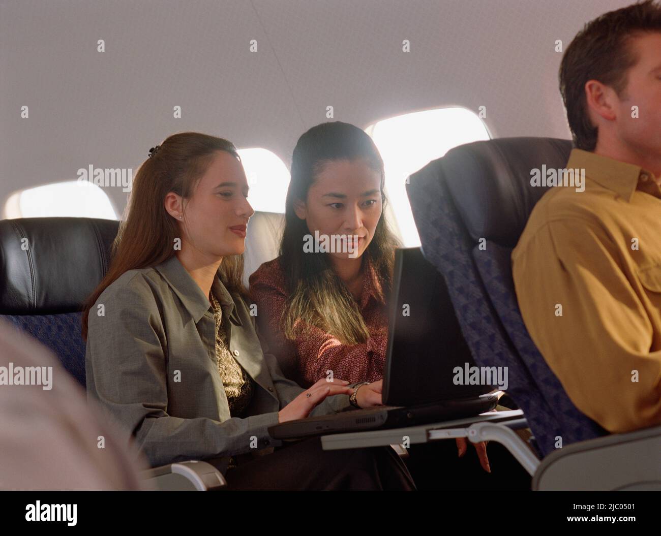 Women using technology in plane hi-res stock photography and images - Alamy