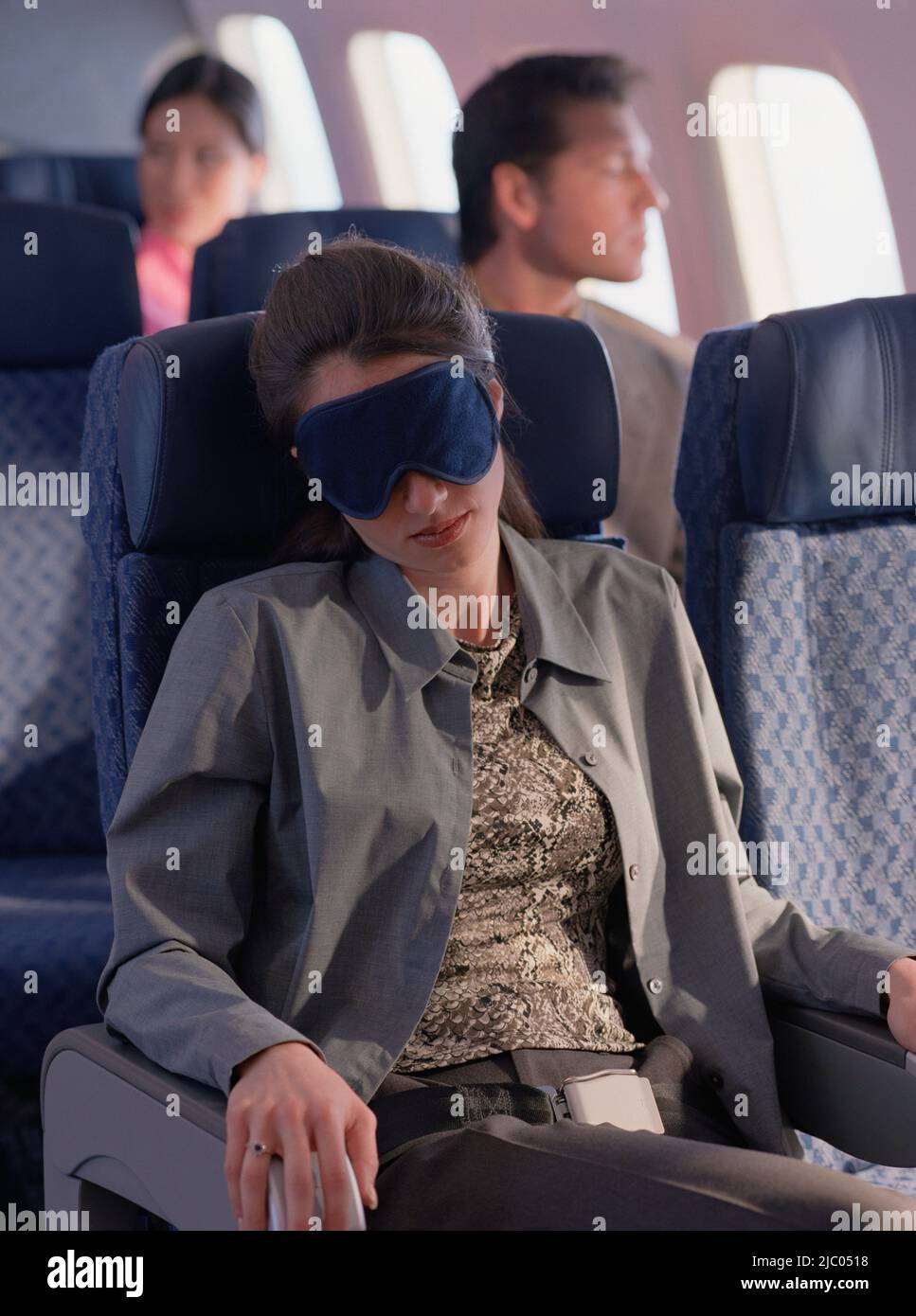 Young woman sleeping on airplane with eye mask Stock Photo Alamy