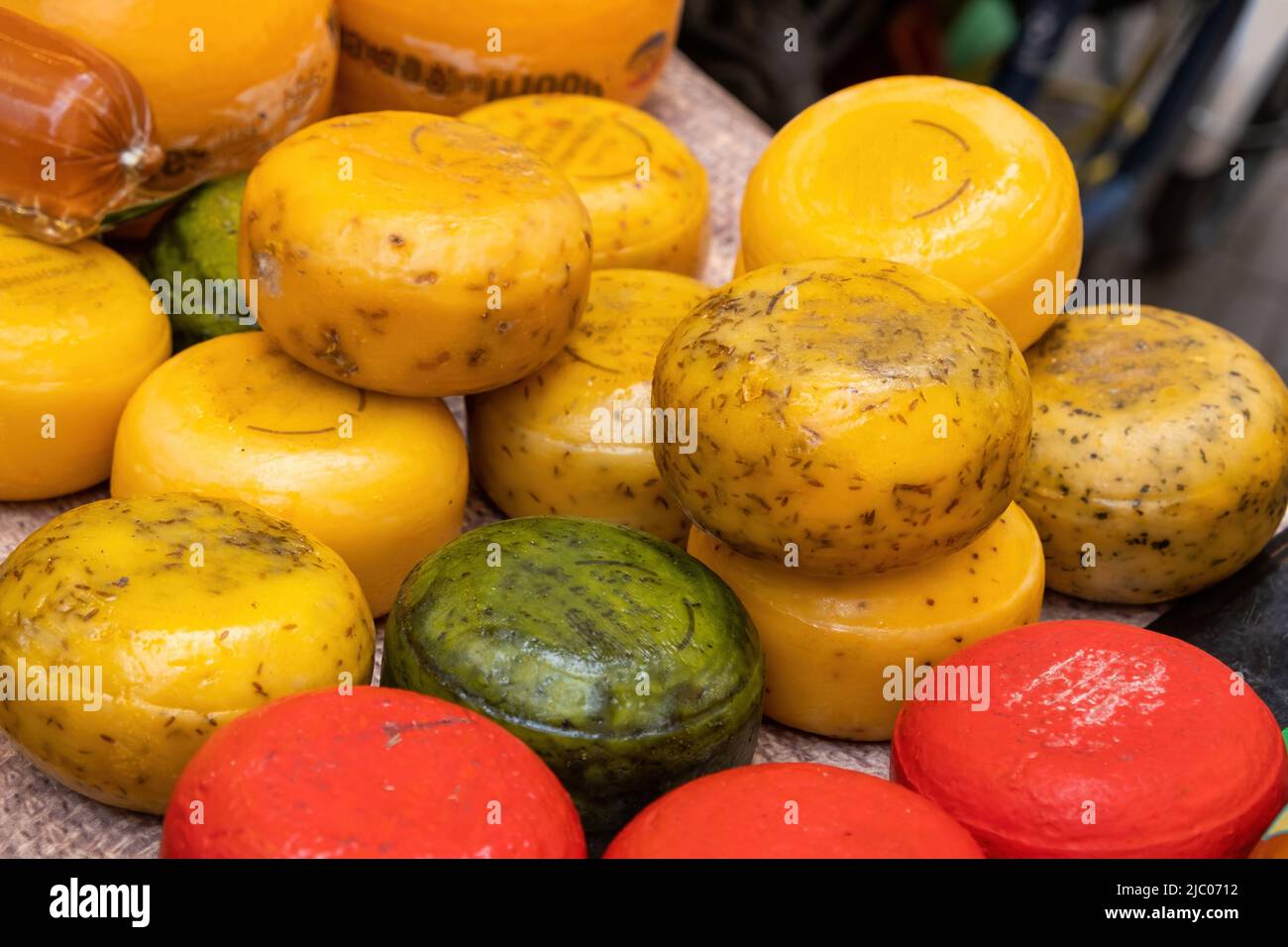 Dutch cheese store. Edam, Gouda whole round wheels for sale on an open air retail stall in Netherlands, close up view Stock Photo