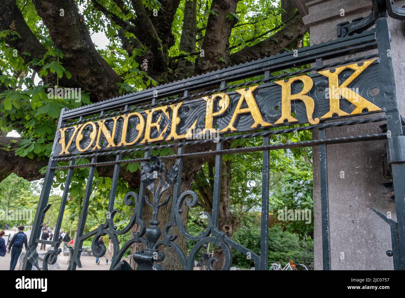 Amsterdam Vondelpark entrance gate open, gold letters text. Vondel park, Dutch public urban garden at the city center. Netherlands Stock Photo