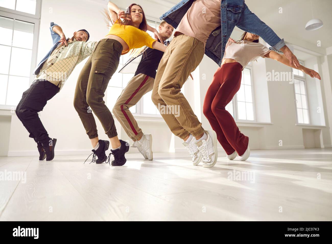 Group of young hip-hop dancers rehearse together and learn new choreography in dance studio. Stock Photo