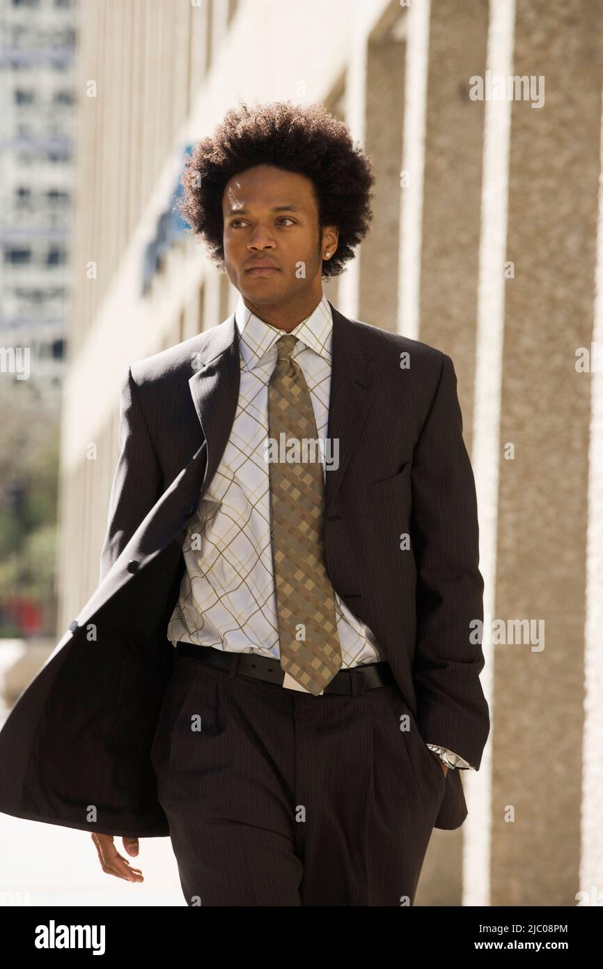 Young black man walking afro hi-res stock photography and images - Alamy