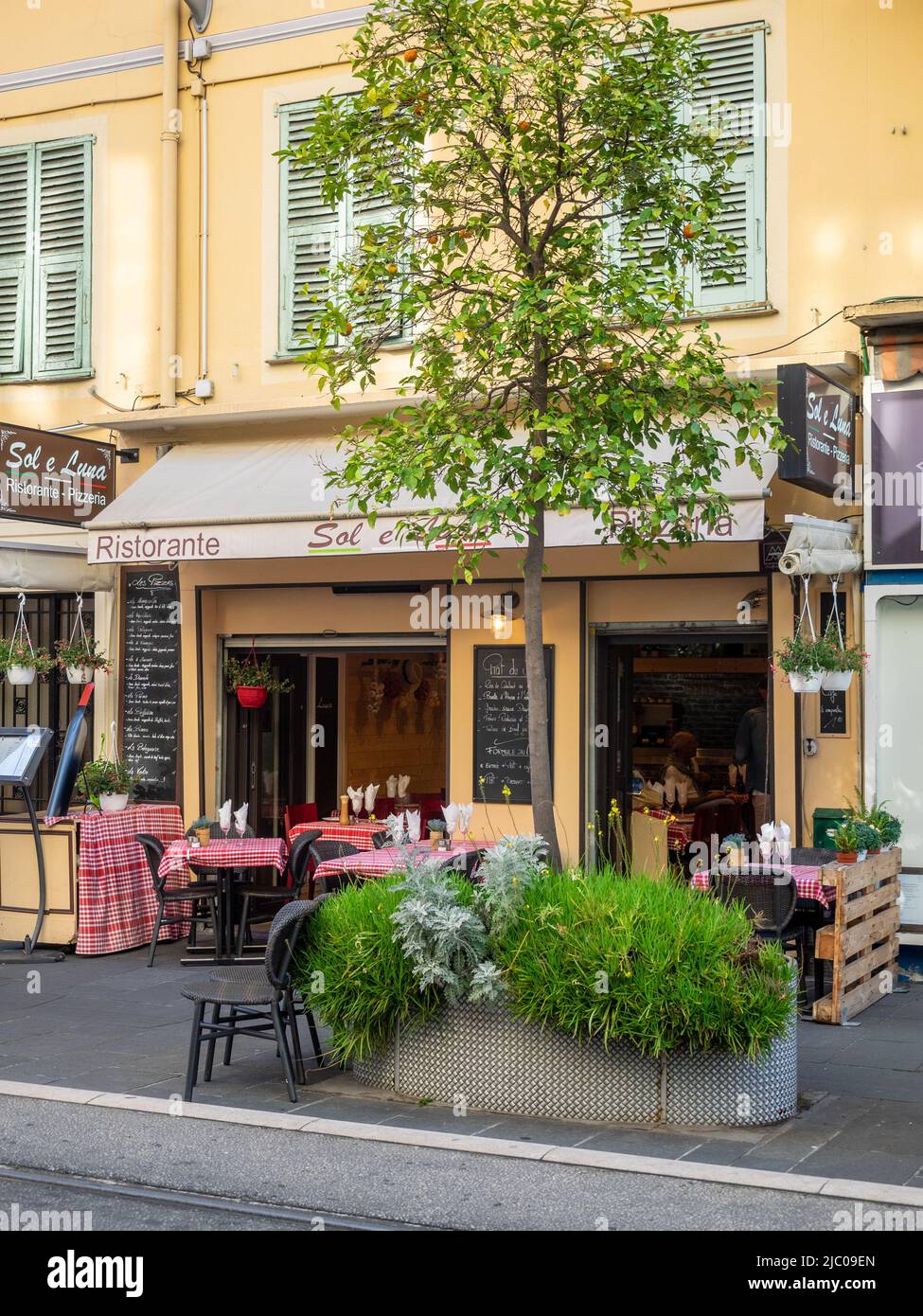 NICE, FRANCE - MAY 25, 2018:  Pretty Sol e Luna restaurant in  Avenue de la Republique with pavement tables Stock Photo