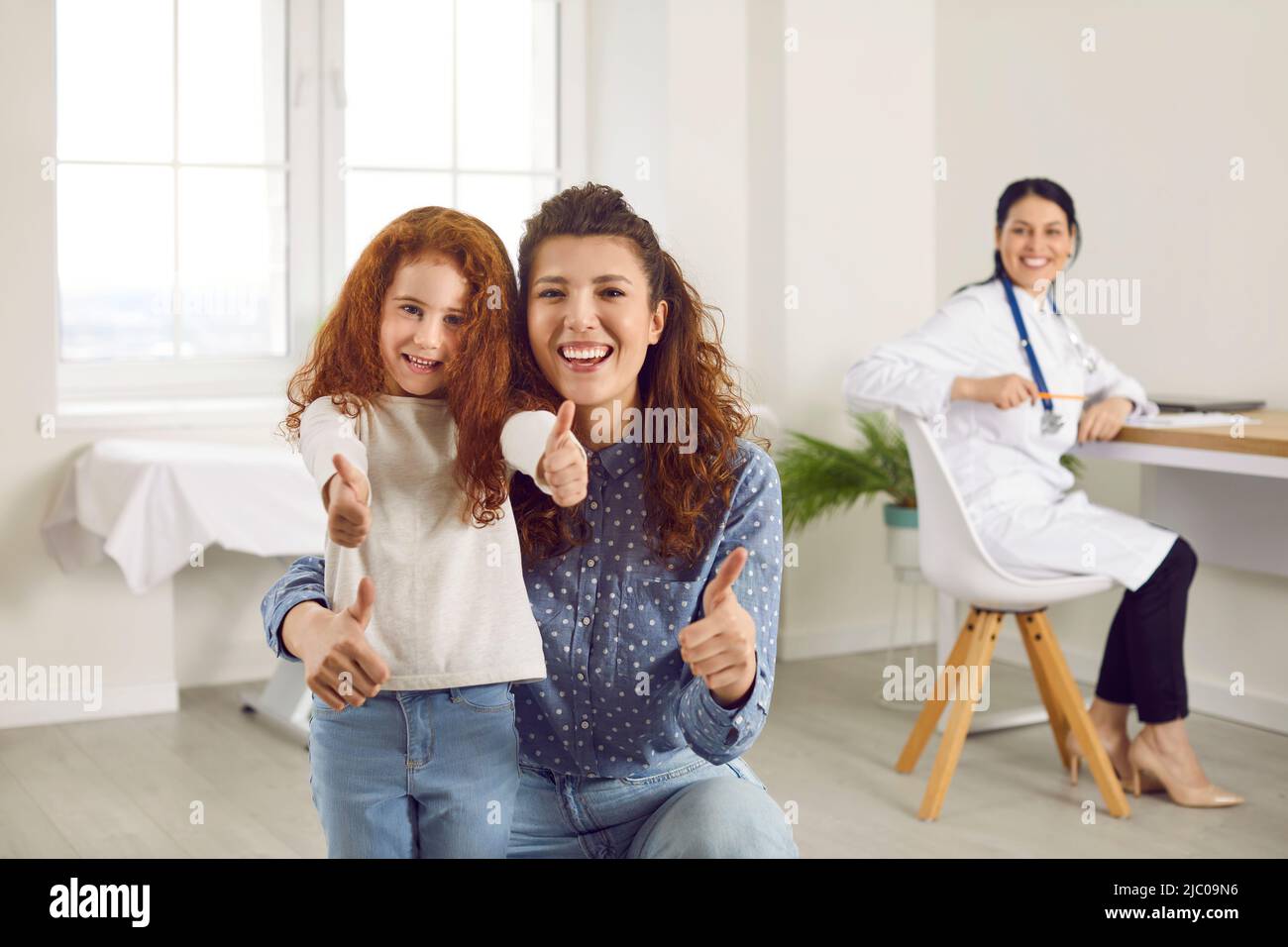 Portrait of happy mother and child giving positive feedback to children ...