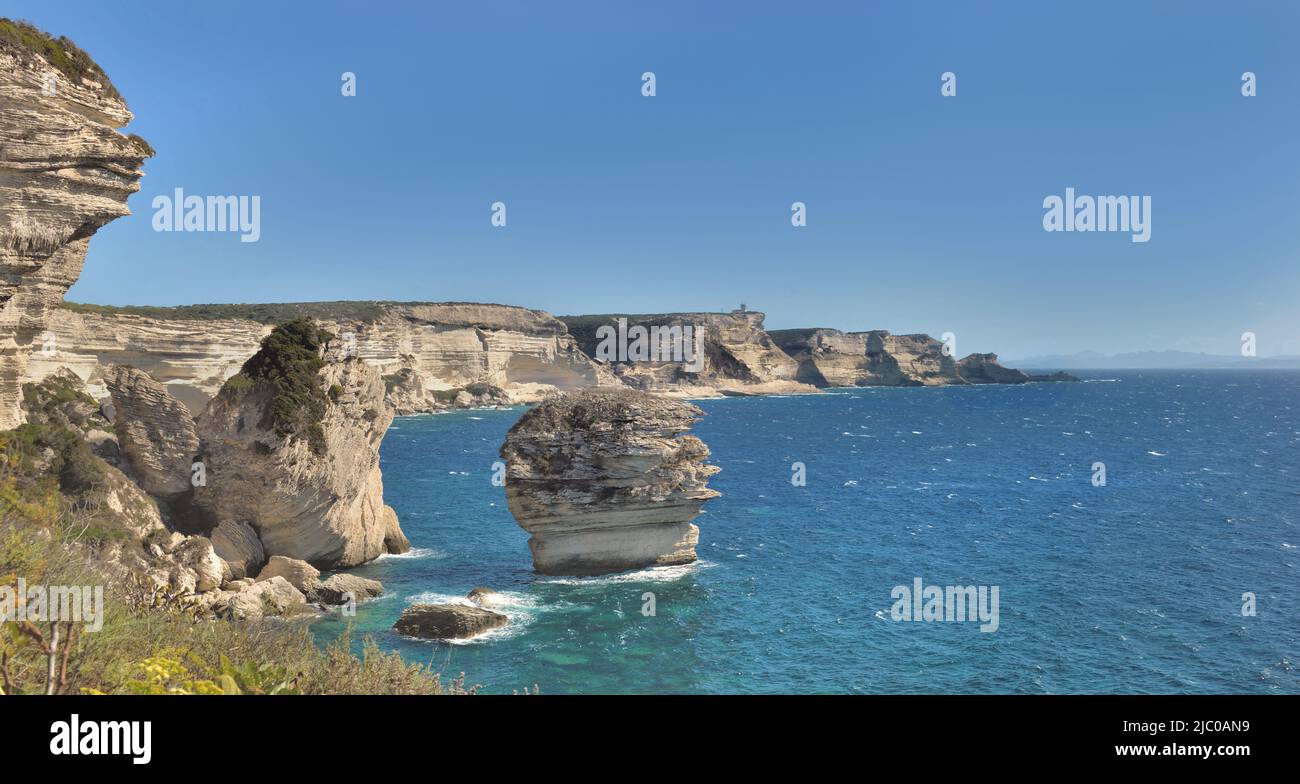 Bonifacio coastline with limestone cliff in the sea under clear blue sky in Corsica Stock Photo