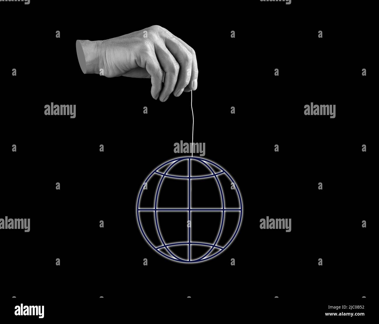 Hand holding earth layout by strings. Manipulation, globalization concept. Negative person influence on planet, ecology. Black and white. High quality photo Stock Photo