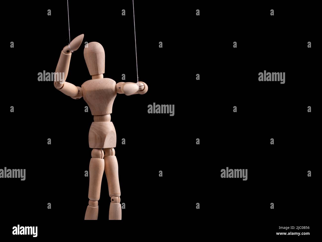 Banner with puppet on strings. Manipulation, control, abusive relationship or addiction concept. Marionette in human hand. Copy space. High quality photo Stock Photo