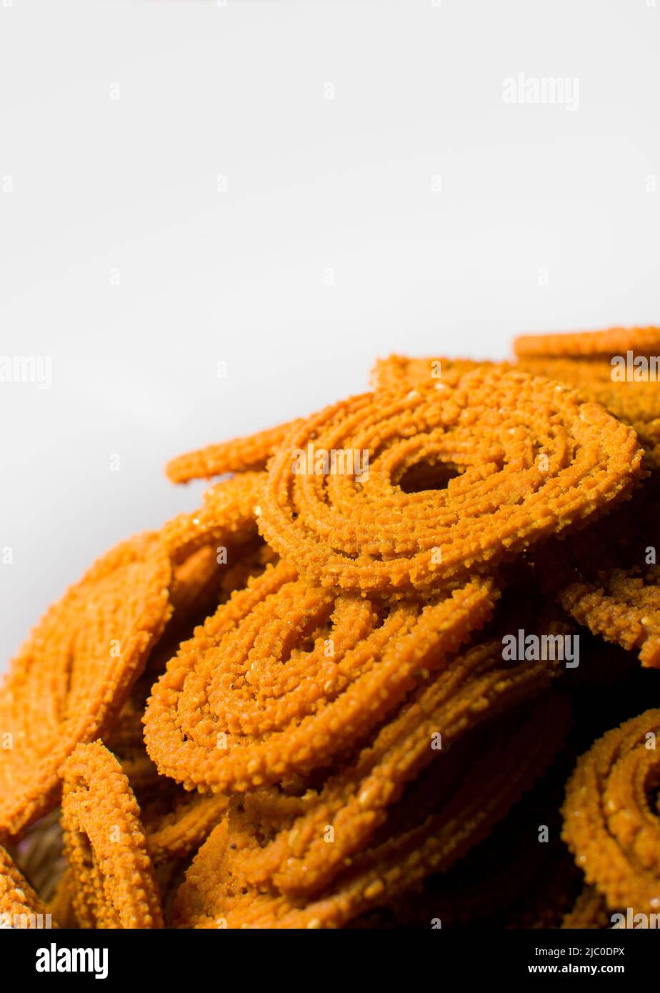 It is spiral and spiked surface Indian snack known as Chakli which made of Bengal gram flour and spices. It is made during Diwali festival. Stock Photo