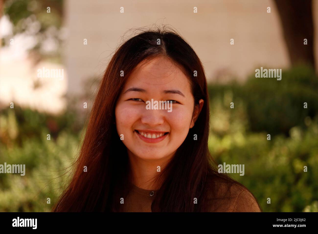 beautiful charming young asian lady in close up in an outdoor Stock Photo