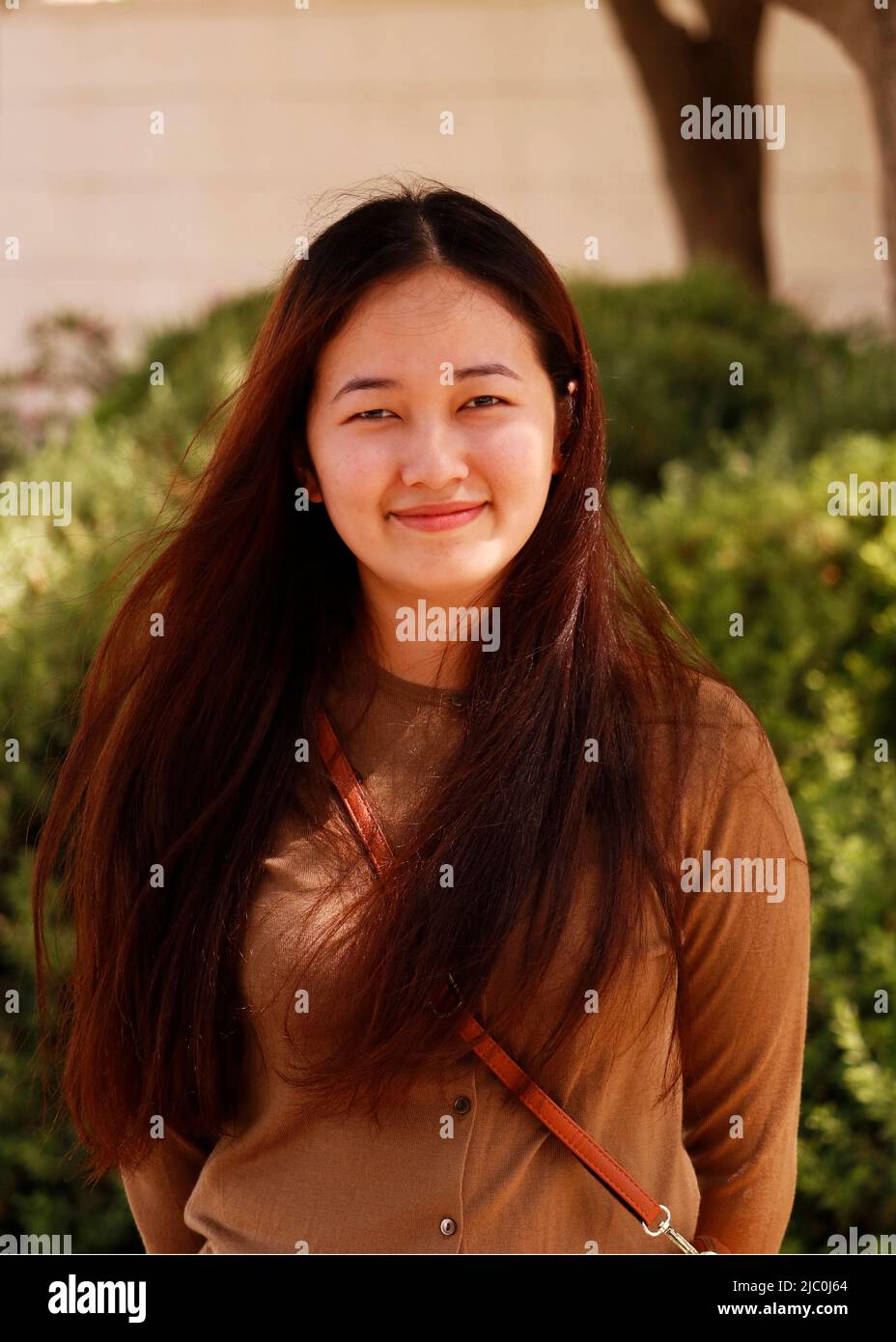 portrait of beautiful young Indian lady in close up in an outdoor with brown costume Stock Photo