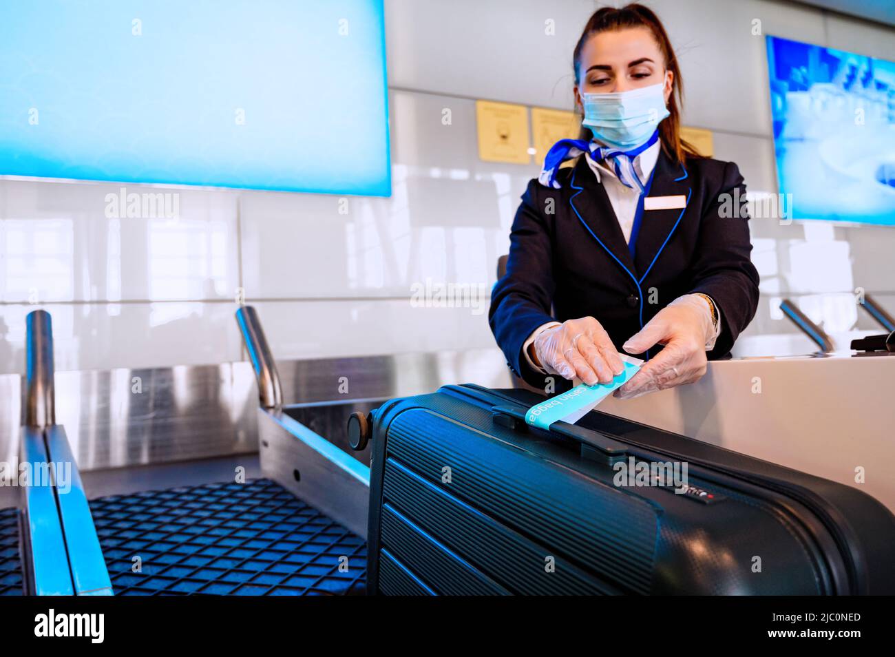 Beautiful girl checkingin passengers' baggage. Registration of luggage
