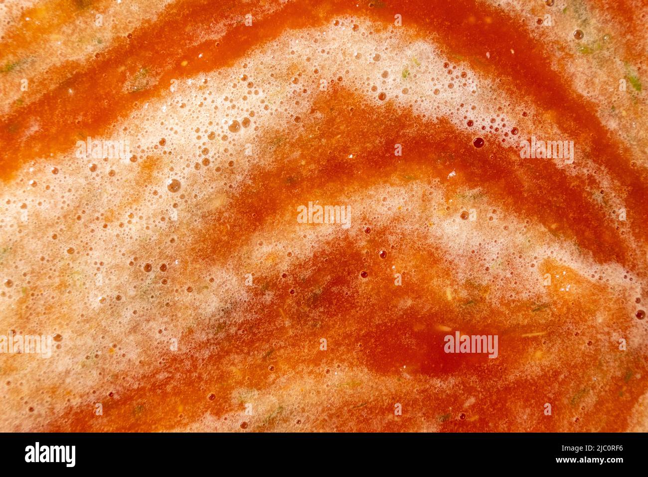 Tomato vegetable sauce boiling in saucepan in the process of cooking