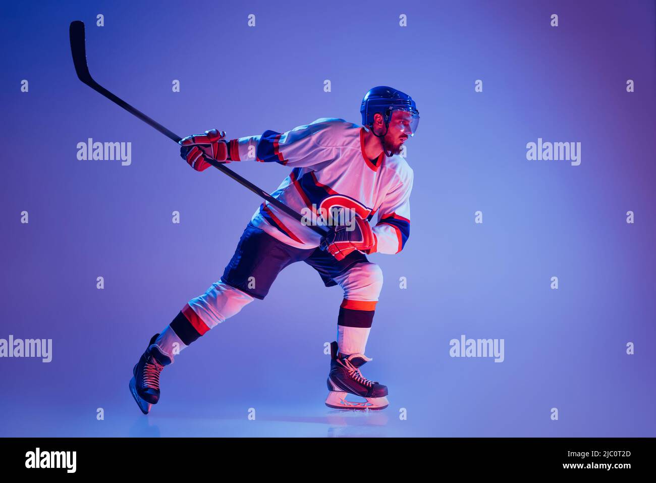 In action. Professional hockey player in sports uniform and protective equipment skating