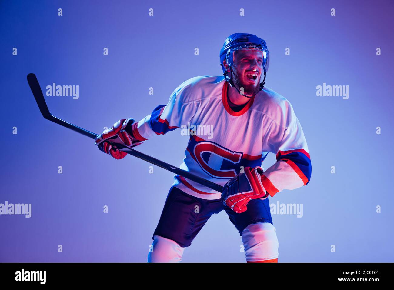 In action. Professional hockey player in sports uniform and protective