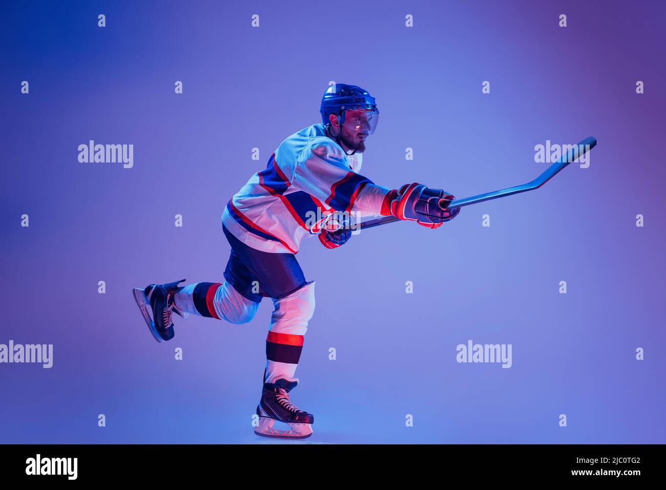 In action. Professional hockey player in sports uniform and protective