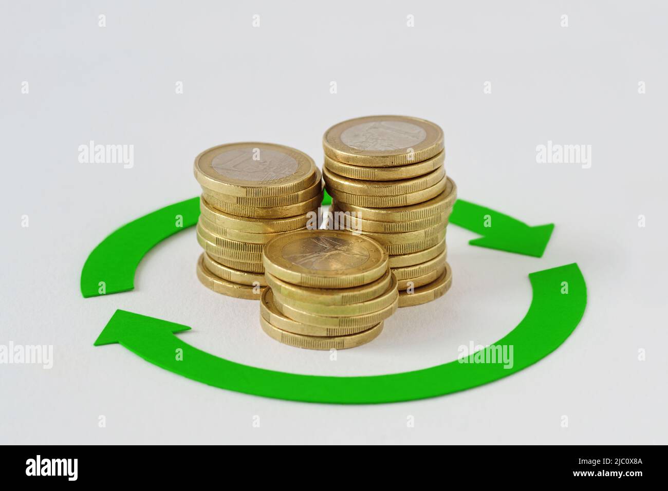 Circle arrows with euro coins stacks - Concept of finance, cash back and money circulation Stock Photo