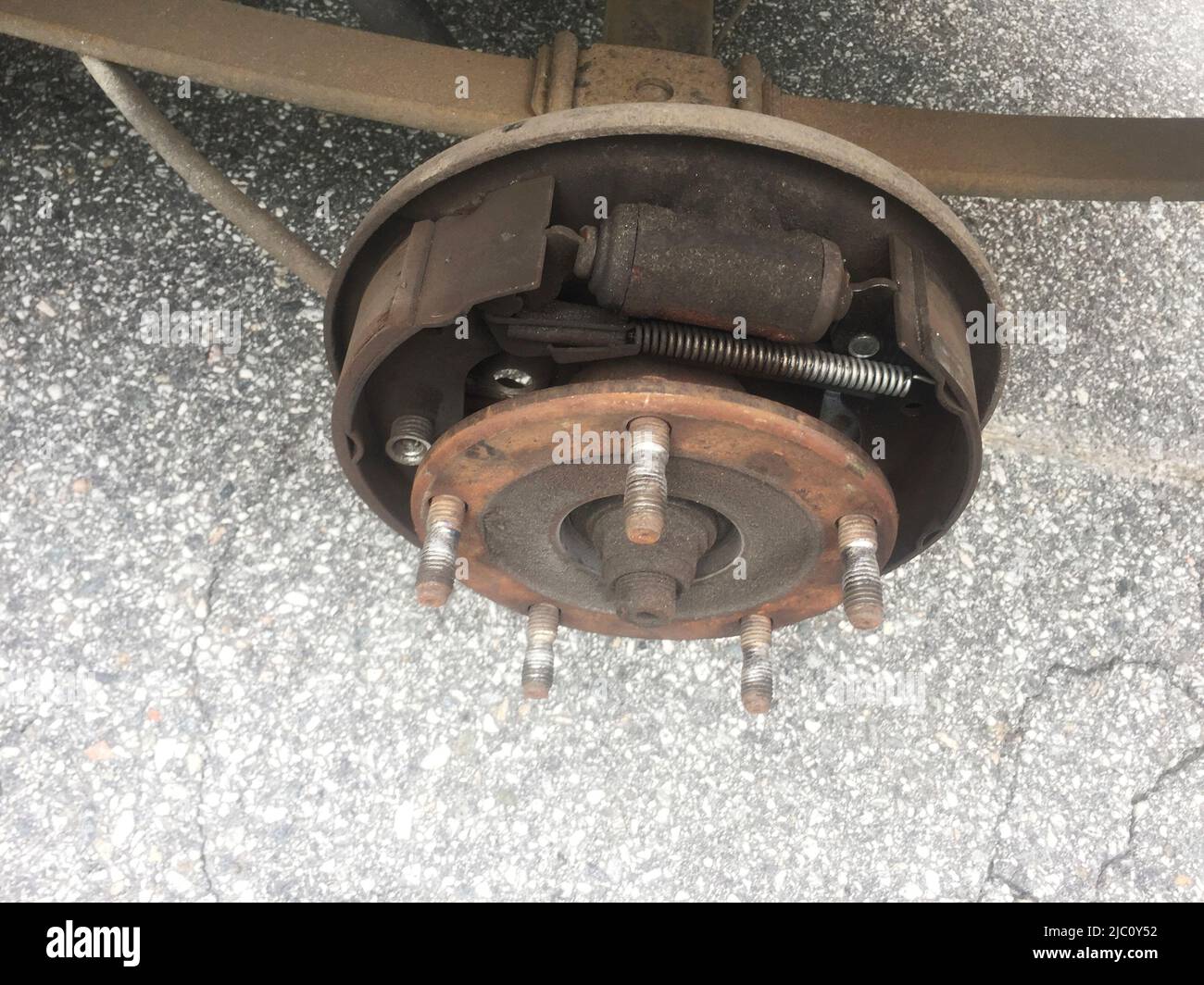Illustrative photo, Ford Transit,rusty rear car wheel hub with drum brake system and suspension Illustrative photo, Ford Transit,rusty rear car wheel hub with drum brake system and suspension