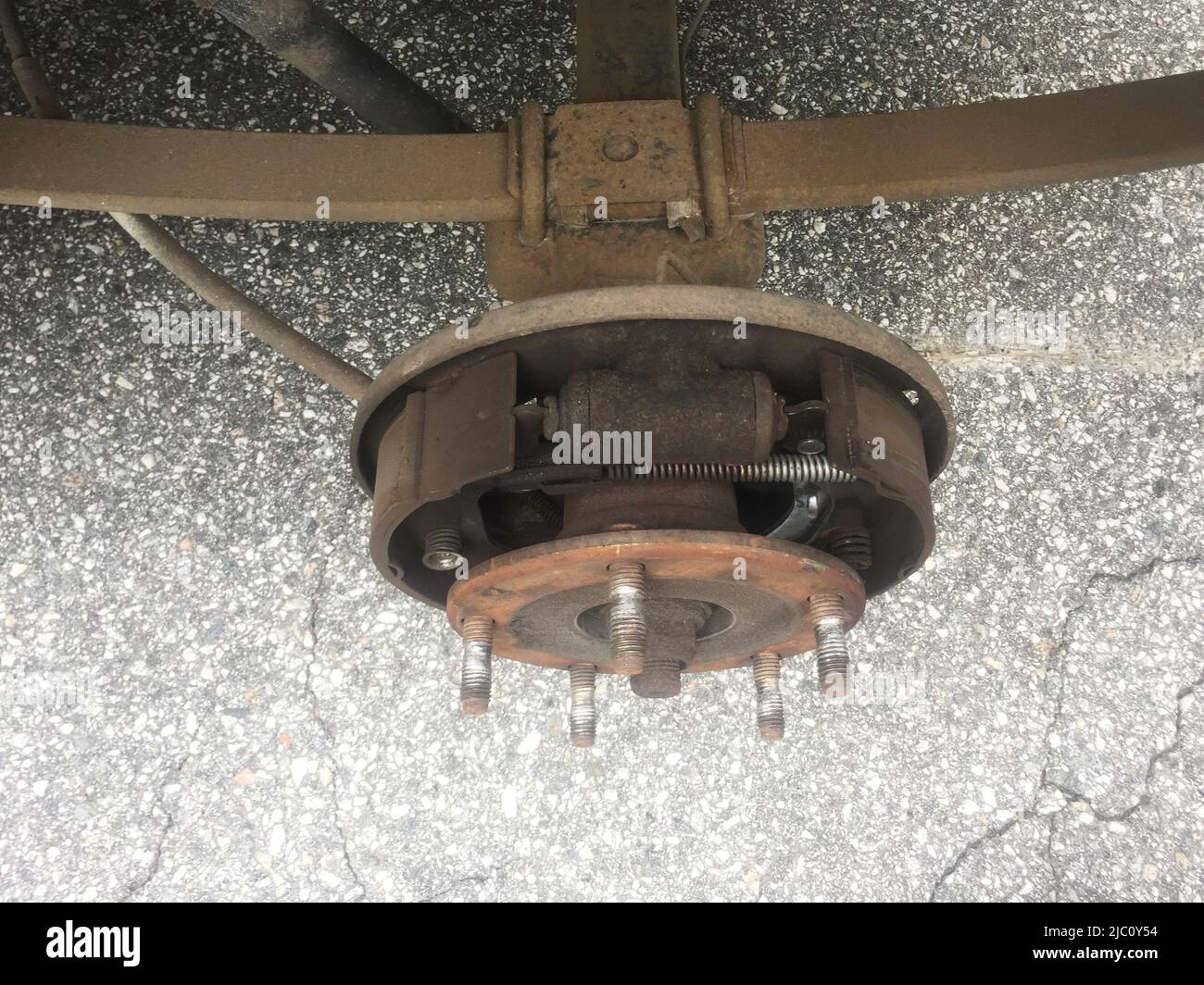 Illustrative photo, Ford Transit,rusty rear car wheel hub with drum brake system and suspension Illustrative photo, Ford Transit,rusty rear car wheel hub with drum brake system and suspension