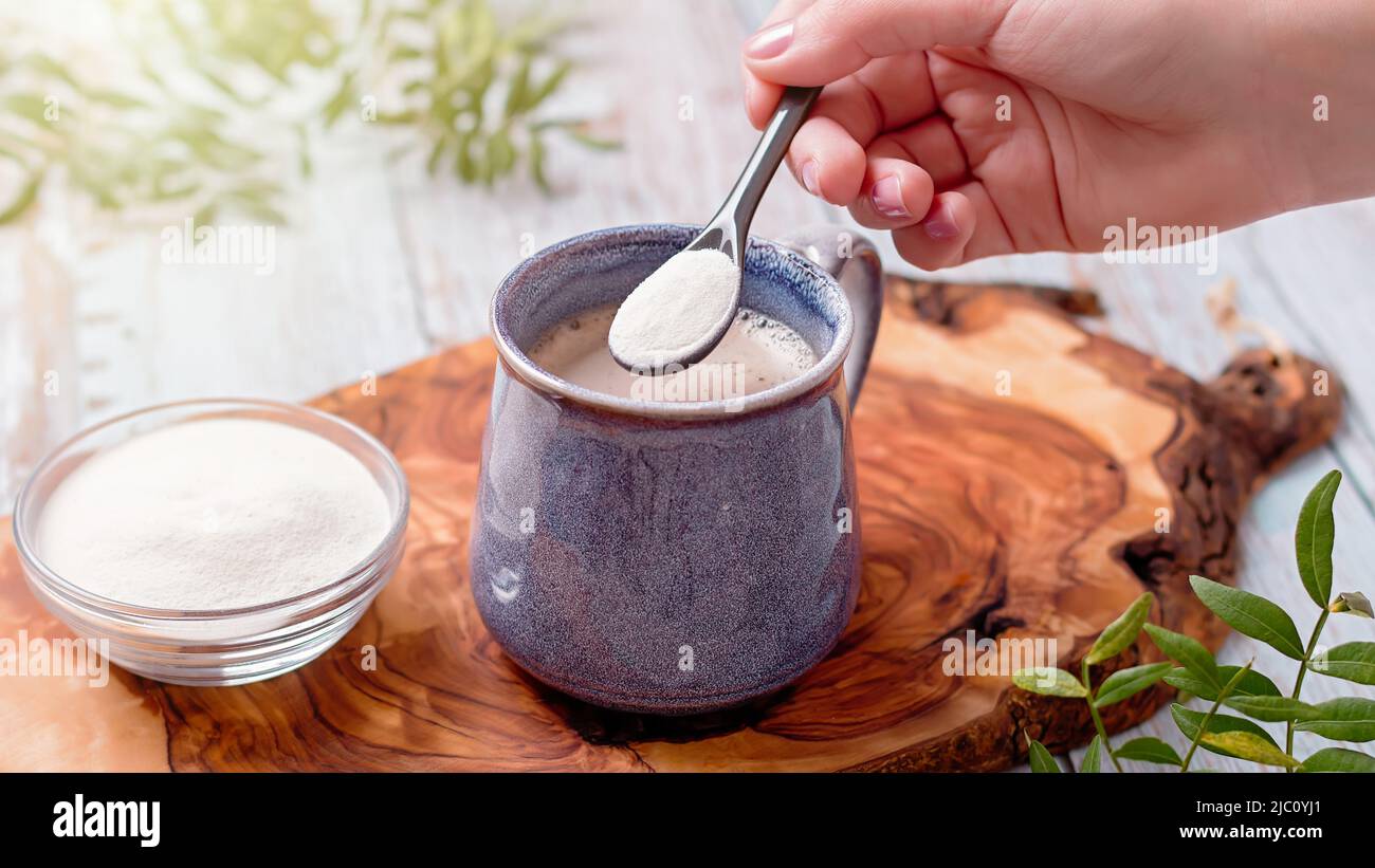 Coffee and collagen powder on wooden board. Collagen supplement with