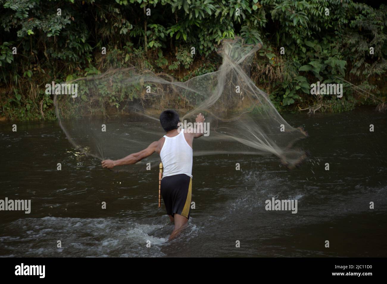 Utik Fish A man throwing a fishing net on a river in Sungai Utik, Batu Lintang ...