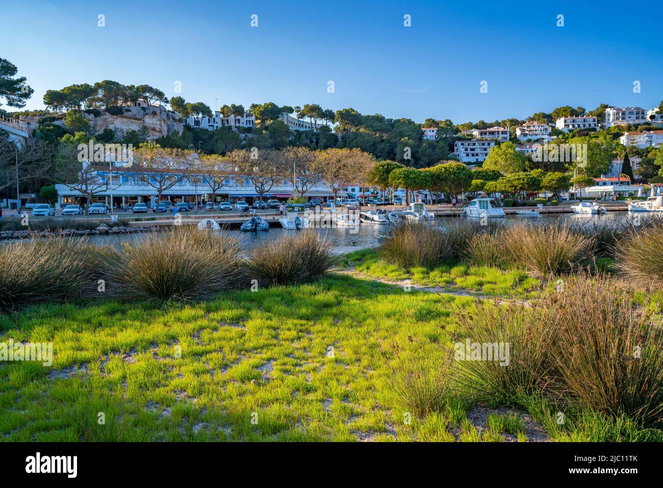 View of hotels overlooking boats at marina in Cala Galdana, Cala Galdana, Menorca, Balearic Islands, Spain, Europe Stock Photo