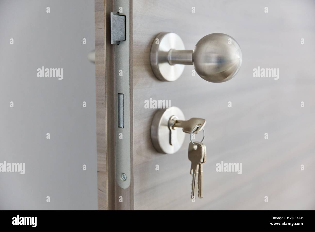 New apartment door with doorknob and key in door lock Stock Photo - Alamy