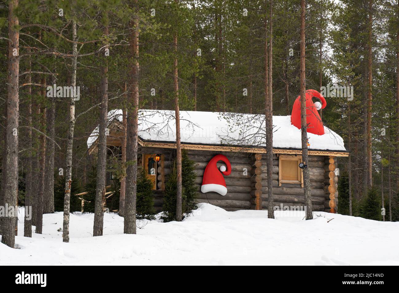 Santa's Village, Finland - March 20th, 2022: A wooden hut decorated with Santa hats, in Santa's village, Finland. Stock Photo