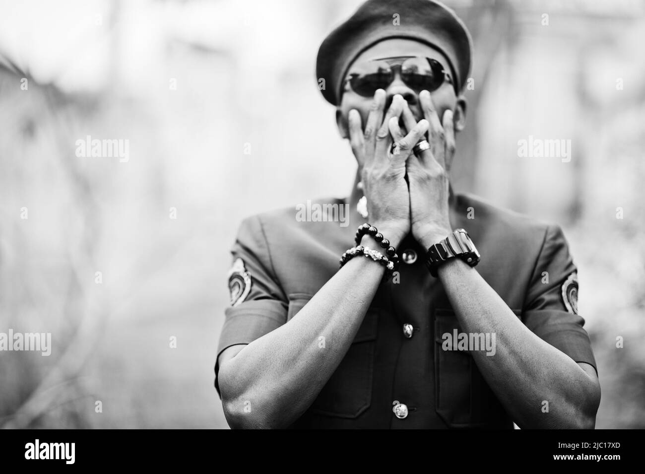 Portrait of African American military man in red uniform, sunglasses