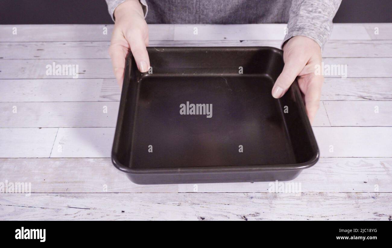 Step by step. Lining the baking pan with cooking foil to make homemade fudge Stock Photo Alamy