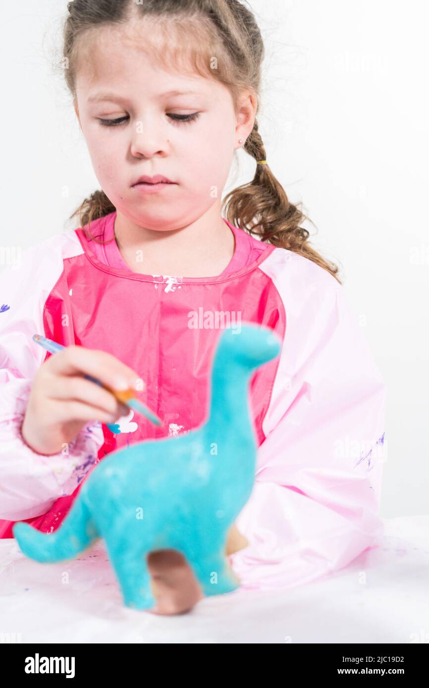 Homeschooling during COVID19 lockdown. Little girl painting paper