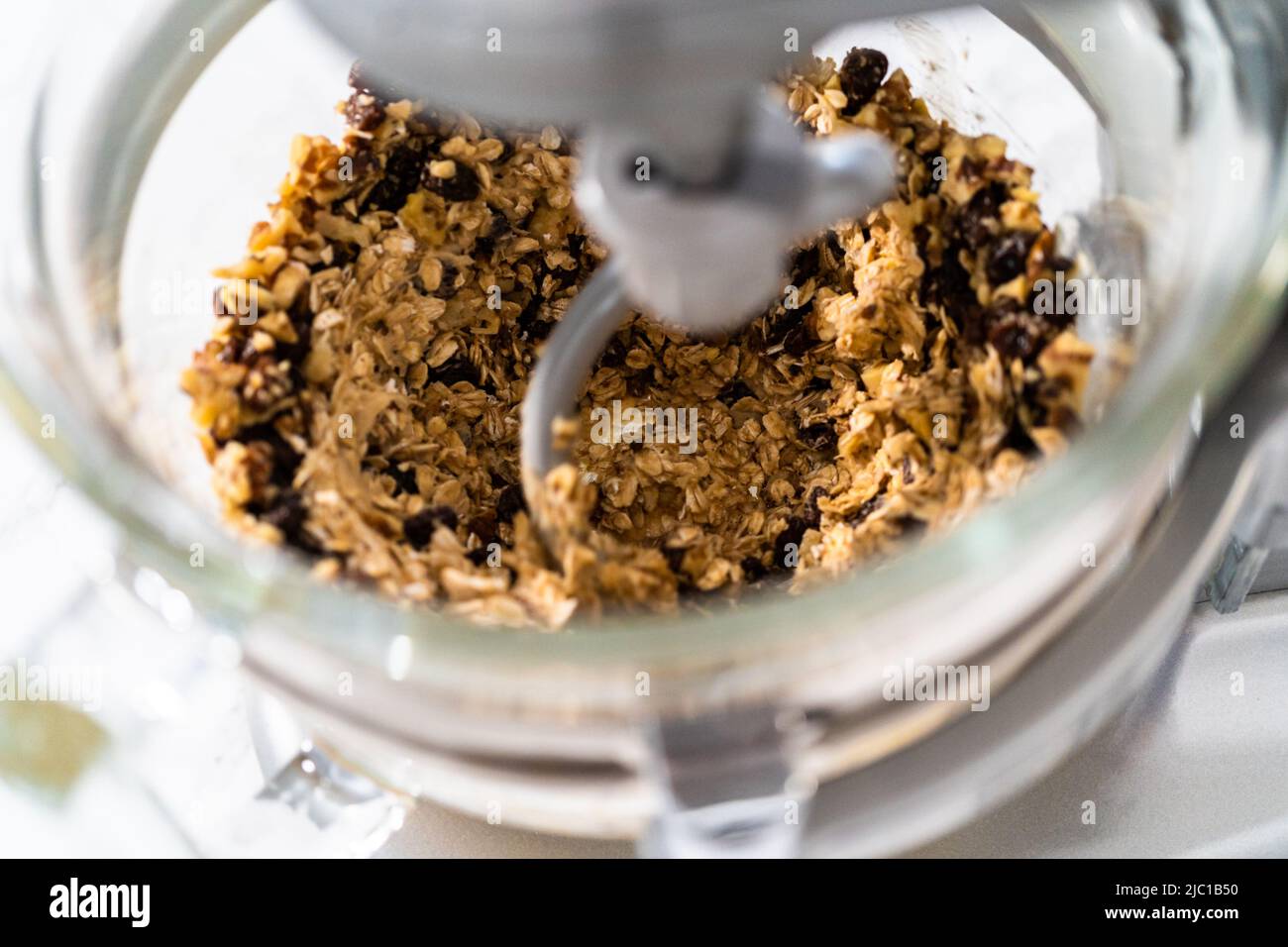 Mixing ingredients in a kitchen stand mixer to bake soft oatmeal raisin