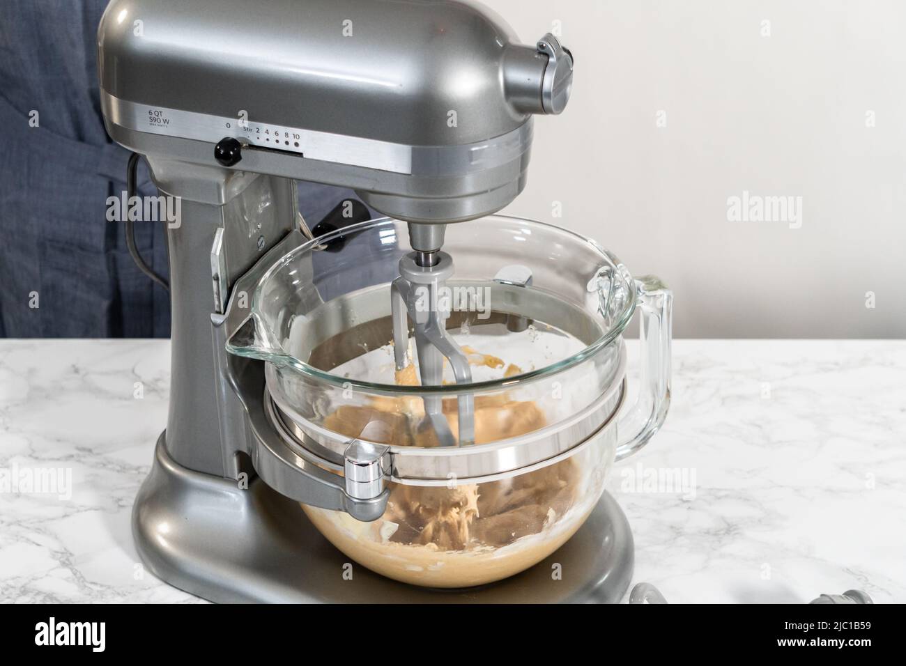 Mixing ingredients in a kitchen stand mixer to bake soft oatmeal raisin