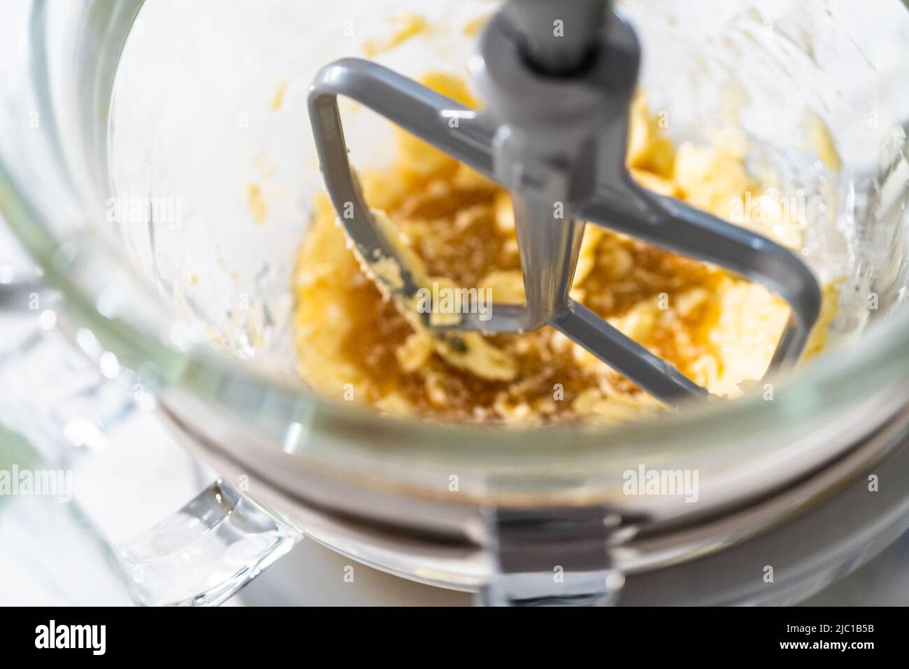 Mixing ingredients in a kitchen stand mixer to bake soft oatmeal raisin