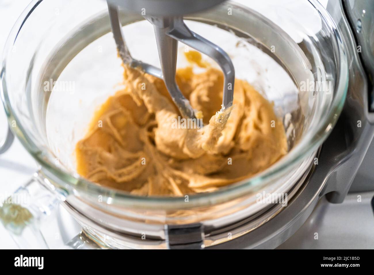 Mixing ingredients in a kitchen stand mixer to bake soft oatmeal raisin