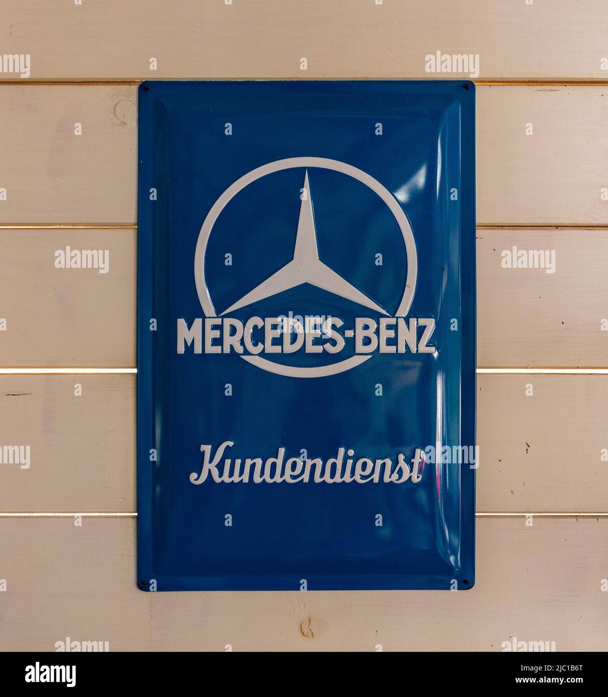 A picture of an old Mercedes Benz logo. The word below reads as