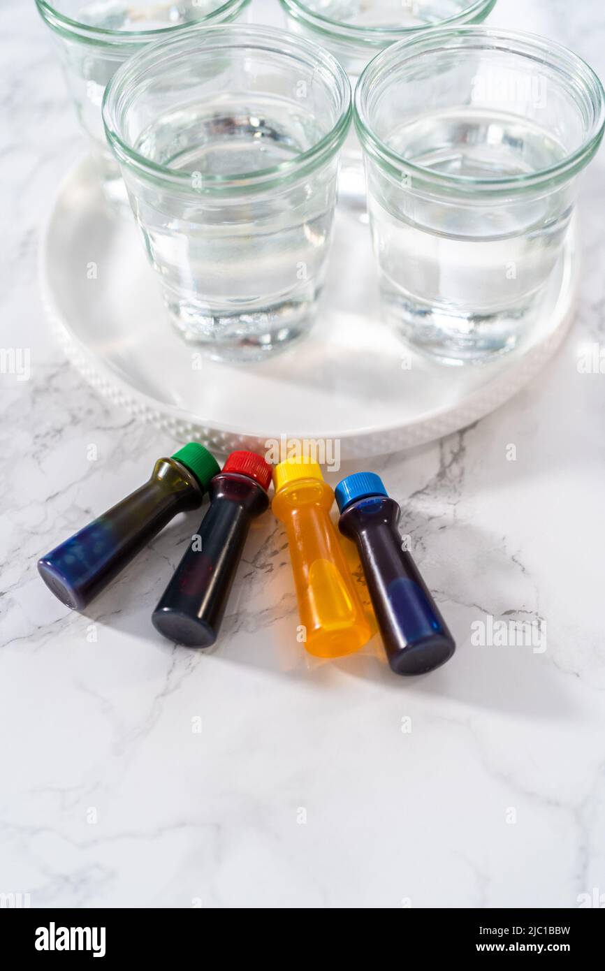 Coloring hardboiled white eggs with natural food coloring Stock Photo