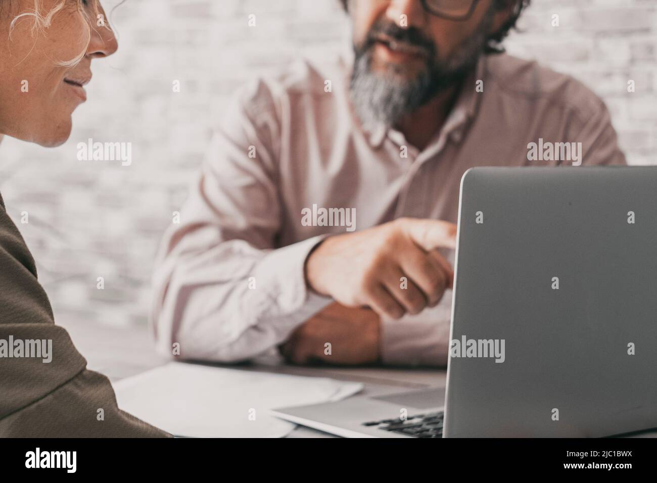 Close up of couple working together on laptop computer. Man show at ...