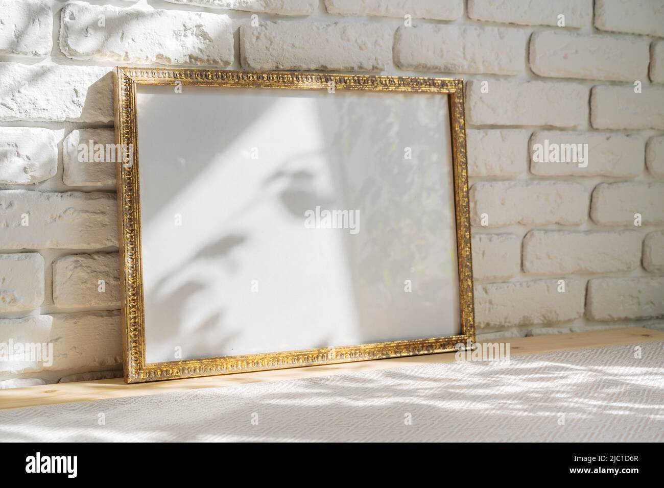 Photo frames on floor over white brick wall Stock Photo