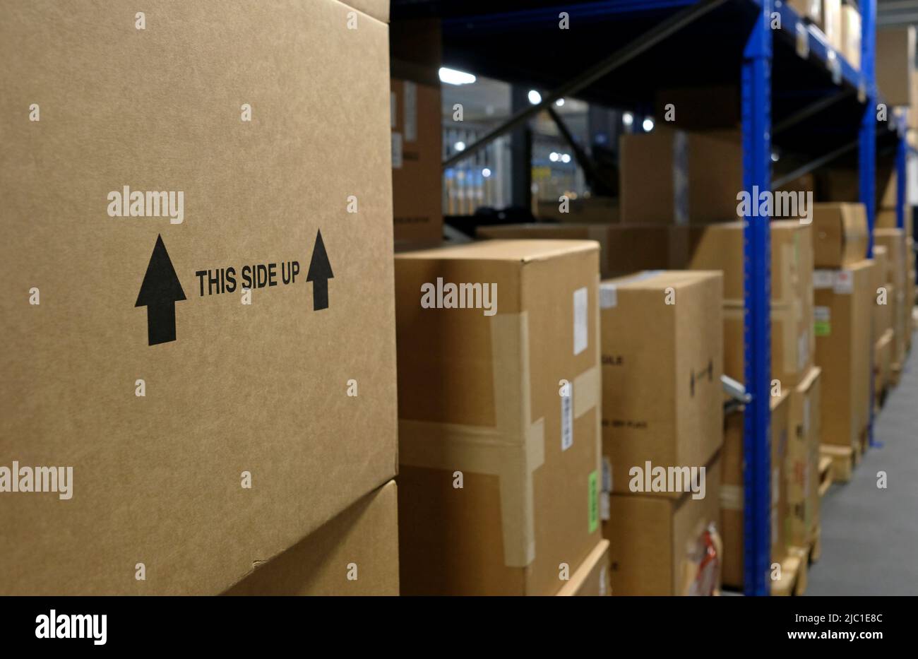 Box inside a distribution warehouse with the words "This Side Up