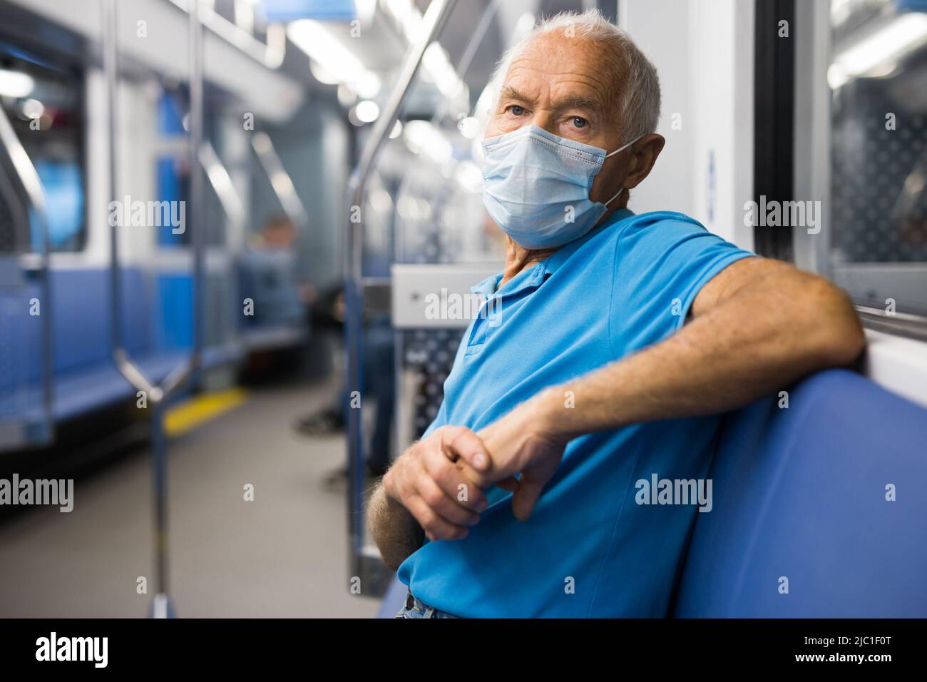 Old man in face mask sitting in subway car Stock Photo - Alamy