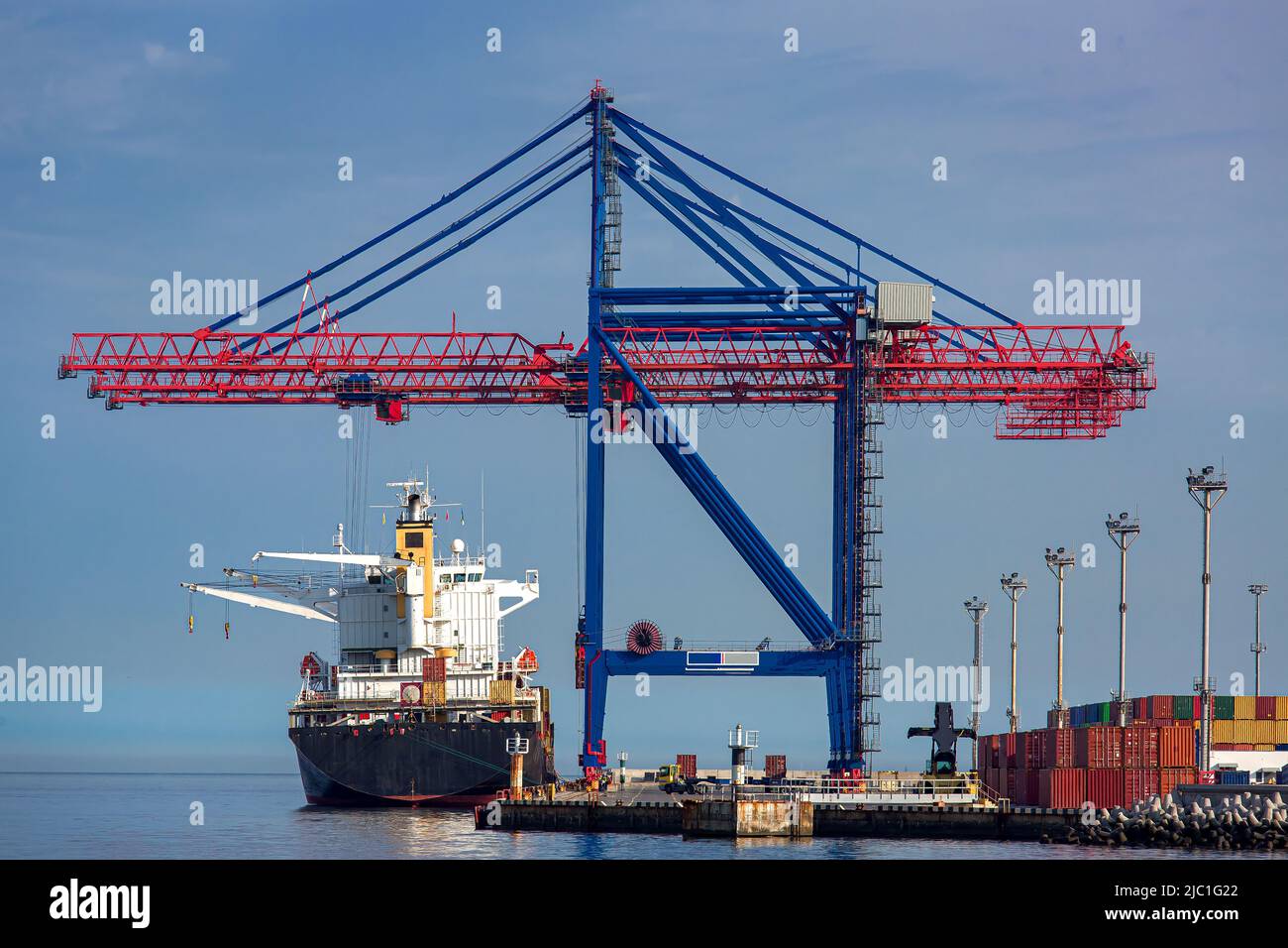 Cargo ship moored at the berth of the container ship yard for loading ...