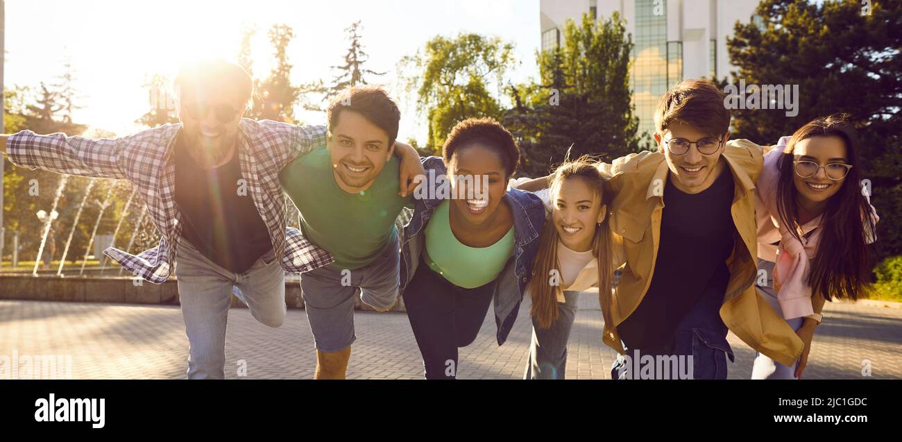Group of cheerful young international friends hanging out and having fun together Stock Photo