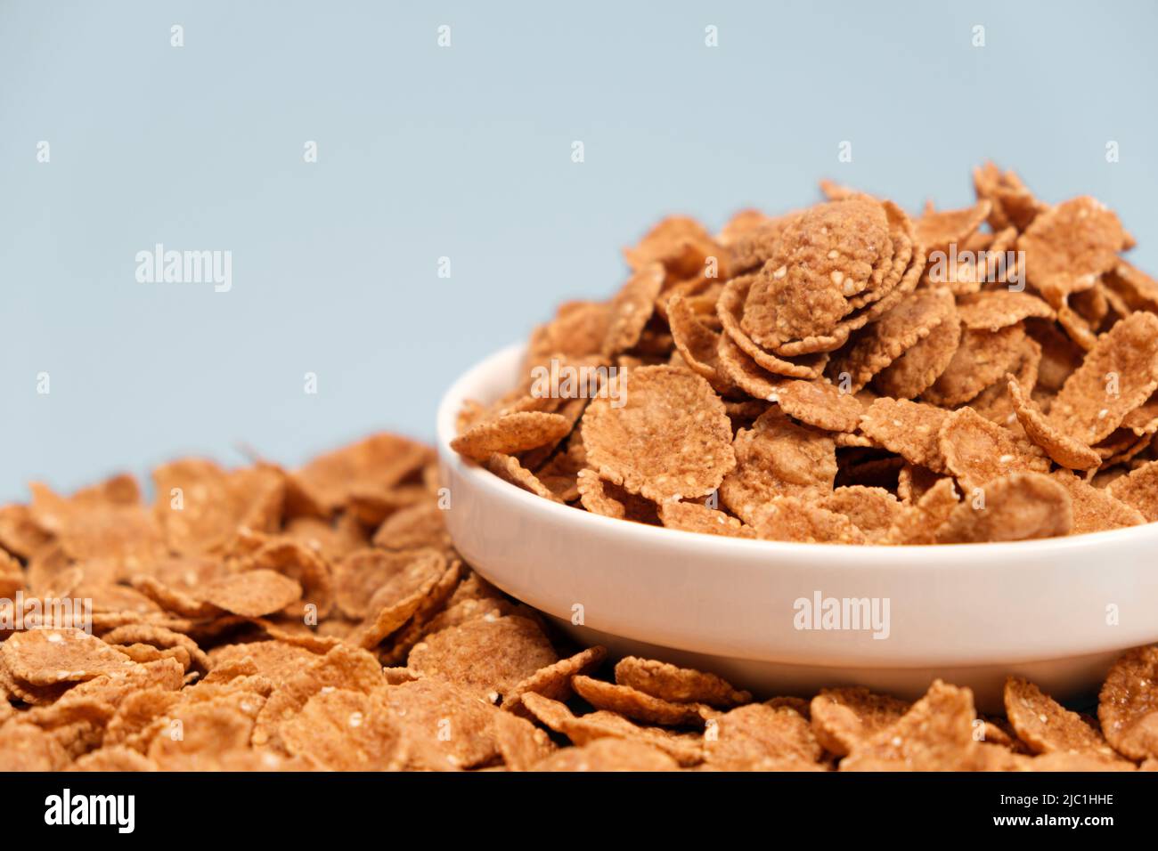 Durum wheat flakes - quick breakfast cereal on a plate on a yellow  background, space for text Stock Photo - Alamy