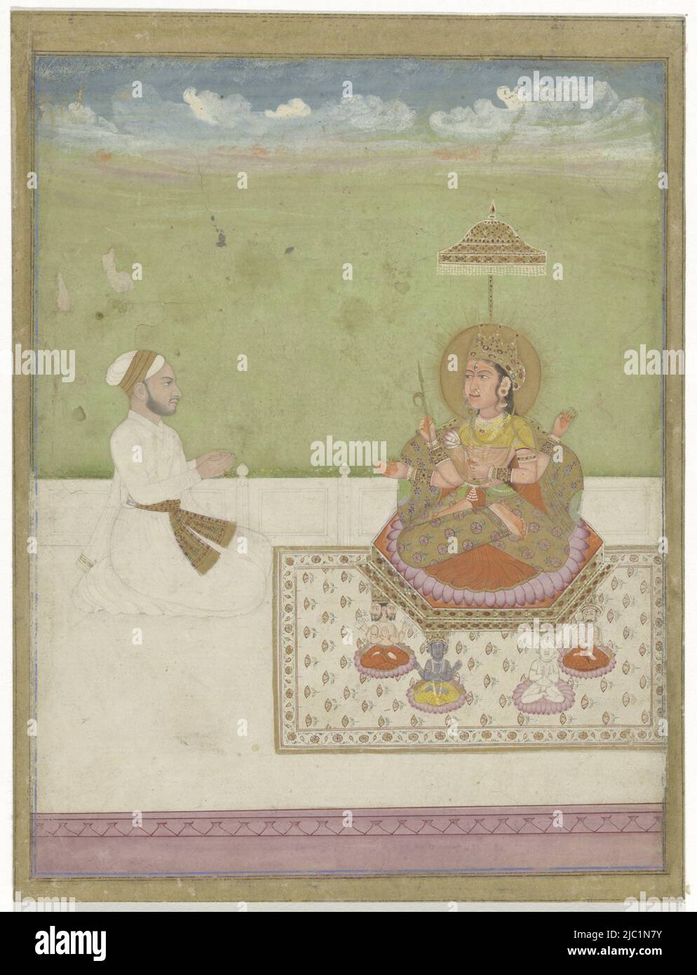 The goddess with two pairs of arms and sitting on a throne of which the legs are made up of gods, a man in white attire is kneeling in front of her, behind the white terrace with lilac underneath a green surface with a blue, white-cloudy sky. Around the picture framing lines in blue and black and a narrow gold-colored piping, Devi on throne with gods as legs., draughtsman: anonymous, Guler, 1750 - 1770, paper, brush, h 228 mm × w 172 mm, h 207 mm × w 163 mm Stock Photo