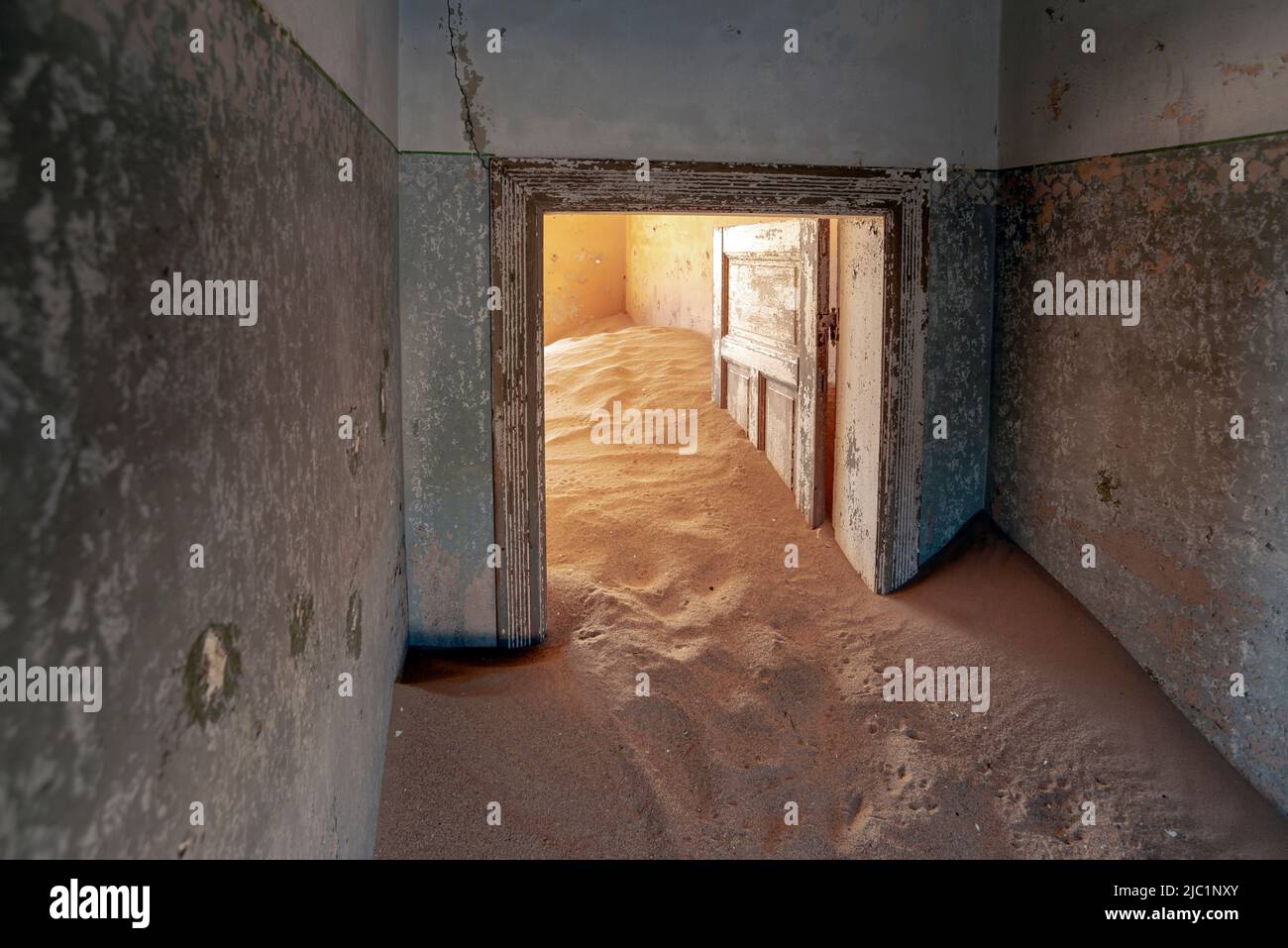 abandoned house interior full of desert sand in Kolmanskop town in Namibia Stock Photo