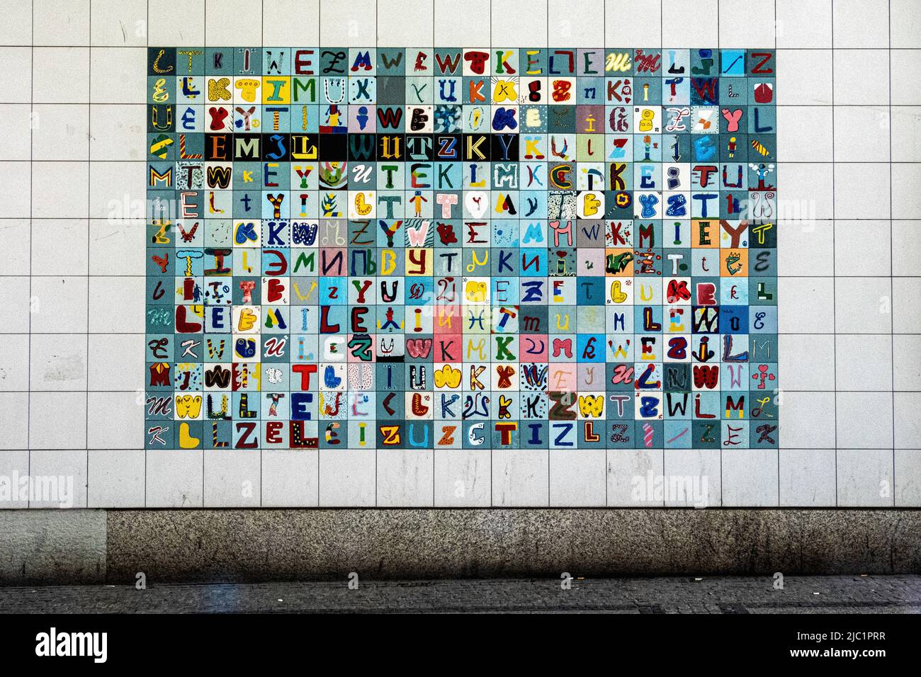 Colourful tiled art work of letters of the alphabet at entrance of Wutzkyallee U-bahn Station,  Joachim-Gottschalk-Weg 21, Gropiusstadt-Berlin,Germany Stock Photo