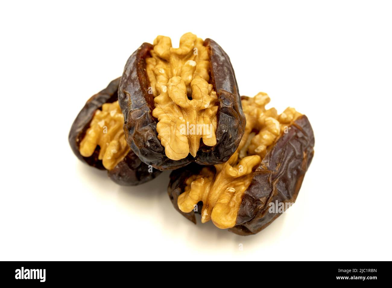 Walnut-stuffed dates isolated on white background. Close-up. Arabian luxury for special occasions such as Ramadan and Eid holidays. local name cevizli Stock Photo