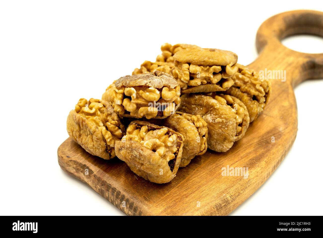Stuffed dried figs. Dried figs stuffed with walnuts isolated on white